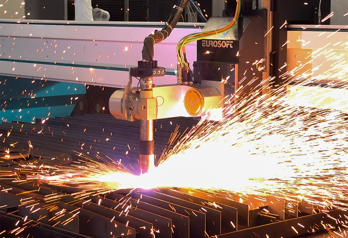 Image of cutting machine with sparks rising as the torch passes over the sheet metal